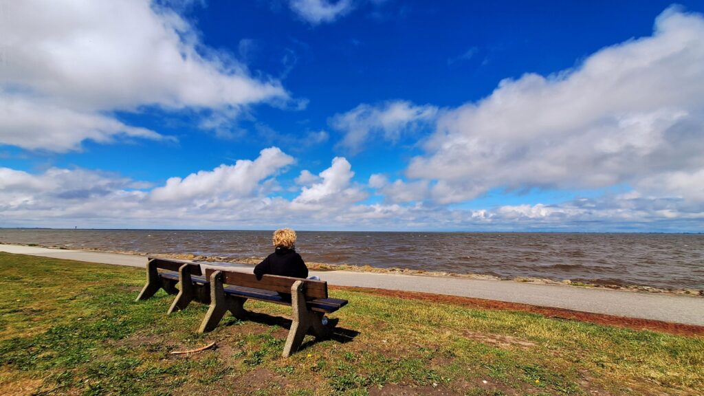 am Nordseestrand auf einer Bank - Blick in die Ferne – Ruhe und Weite bei der Workation erleben